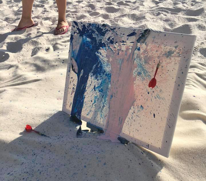 Check out this cute beach gender reveal using paint and a canvas!
