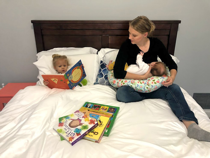 Grab a stack of books to help keep your toddler busy while you breastfeed baby. 