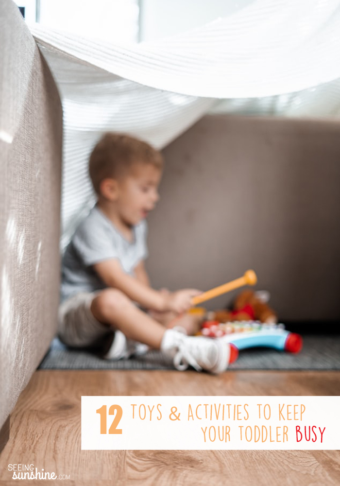 Needing to keep your toddler busy while you cook or nurse the baby? Here's a list of 12 great activities and toys to do just that!